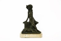 Lot 221 - A 20th century Art Deco style bronze of a seated lady with dog at her feet