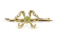 Lot 7 - An Edwardian gold circular cut peridot and seed pearl bow brooch