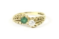 Lot 6 - An 18ct gold emerald and diamond crossover ring