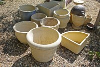 Lot 573 - A collection of reconstituted stone planters