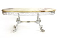 Lot 386 - A low pieced brass oval table