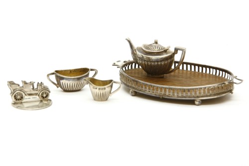 Lot 78 - A miniature silver three piece tea set on a tray