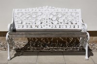 Lot 587 - A white painted aluminium garden bench