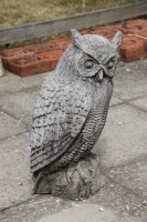 Lot 599 - A life size figure of a long eared owl in cast stone