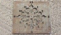 Lot 613 - A large 'Tudor style' pierced metal garden wall panel/clock face