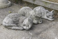 Lot 615 - A set of three composition stone resting/sleeping cats