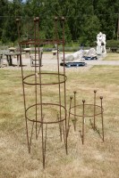 Lot 619 - An early 20th century hand forged wrought iron clematis and rose obelisk with ball finials