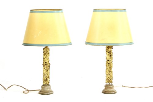 Lot 246 - A pair of Chinese carved gilt wood table lamps with ovoid cream and green shades