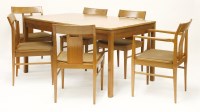 Lot 608 - A teak dining suite