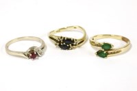 Lot 62 - A gold pear shaped two stone emerald crossover ring
