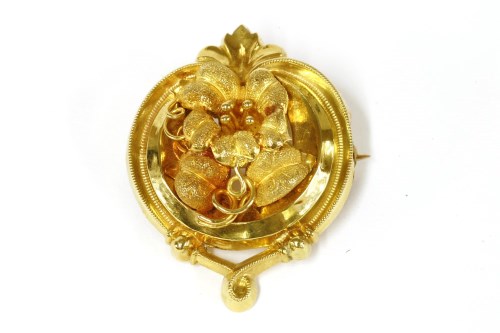 Lot 27 - A Victorian style continental gold floral spray brooch with scroll border