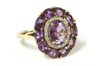 Lot 66 - A 9ct gold oval cut amethyst and two row diamond and amethyst cluster ring