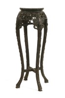 Lot 702 - A Chinese hardwood urn stand