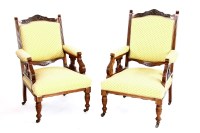 Lot 738 - A pair of Edwardian his and her walnut arm chairs