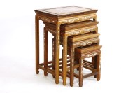 Lot 674 - A nest of four 20th century Chinese rosewood and mother of pearl inlaid occasional tables