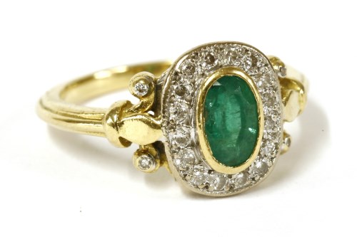 Lot 12 - An 18ct gold emerald and diamond cluster ring
