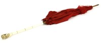 Lot 445 - A late 19th Century red silk parasol