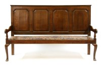 Lot 615 - A 19th century oak four panel settle