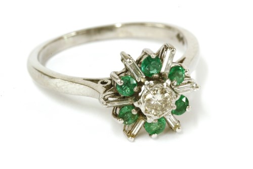 Lot 24 - An 18ct white gold diamond and emerald star burst cluster ring