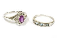 Lot 16 - A white gold purplish/pink sapphire and diamond crossover cluster ring