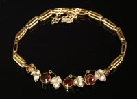 Lot 11 - An Edwardian garnet and split pearl bracelet