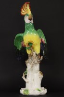 Lot 185 - A Sitzendorf parrot standing on a painted branch