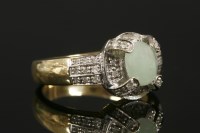 Lot 3 - A 9ct gold jade cabochon and diamond cluster ring