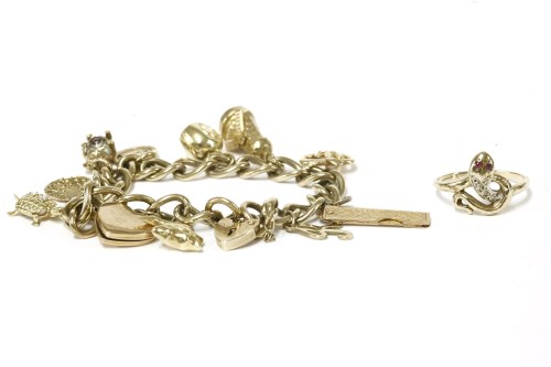 Lot 36 - A gold charm bracelet with 9ct gold padlock and eleven assorted charms