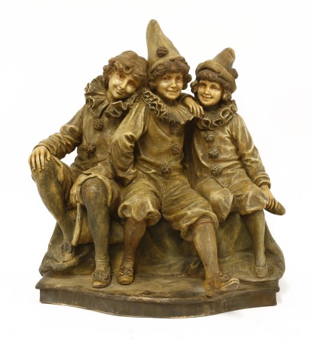 Lot 135 - A Goldscheider figure of three children dressed as clowns