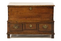 Lot 483 - A small 18th century oak mule chest
moulded rectangular top above three base drawers