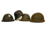 Lot 259 - Four tin helmets