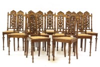 Lot 662 - A set of ten carved oak dining chairs with cane seats