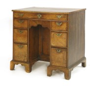 Lot 633 - A George III elm kneehole desk