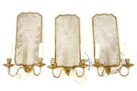 Lot 642 - A set of three twin-branch wall lights