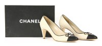 Lot 1390 - A pair of Chanel cream heel court shoes