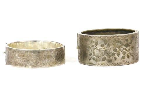 Lot 28 - A silver hinge bangle with engraved top section
