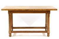 Lot 553 - An Arts and Crafts oak and walnut dining table