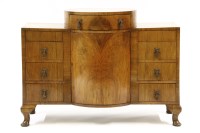 Lot 457 - An Art Deco walnut breakfront dressing table