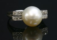 Lot 37 - A single stone cultured pearl ring with diamond set shoulders