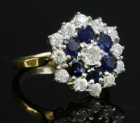 Lot 286 - A diamond and sapphire three-tier cluster ring