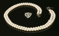 Lot 137 - A two row graduated cultured pearl necklace with a diamond set clasp