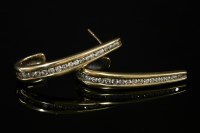 Lot 564 - A pair of diamond set gold elongated half hoop earrings