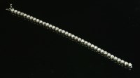 Lot 428 - An 18ct white gold diamond set line bracelet