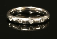 Lot 413 - A platinum diamond set wedding ring