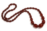 Lot 50 - A single row graduated cherry coloured barrel shaped Bakelite bead necklace