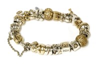 Lot 1482 - A sterling silver and 14ct gold Pandora bracelet