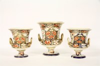Lot 309 - Three early 19th Century Derby porcelain twin handled campana urns