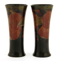 Lot 101 - A near pair of Moorcroft 'Pomegranate' vases