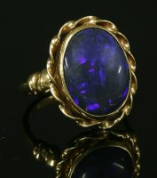Lot 205 - A gold single stone black opal ring