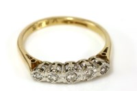 Lot 145 - A gold illusion set five stone diamond ring